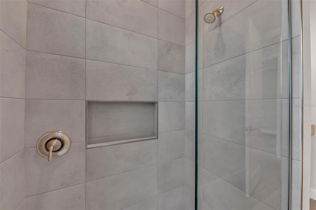 bathroom with tiled shower