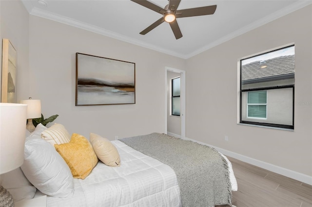 bedroom with ceiling fan, ornamental molding, and light wood-type flooring