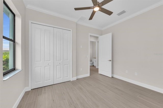 unfurnished bedroom featuring ceiling fan, ornamental molding, and a closet