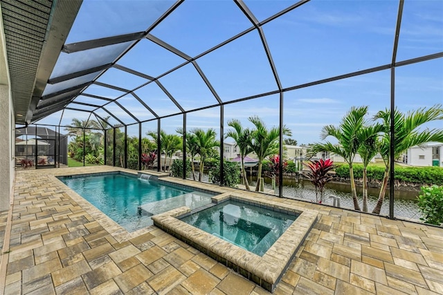 view of swimming pool featuring a patio area, a water view, glass enclosure, and an in ground hot tub