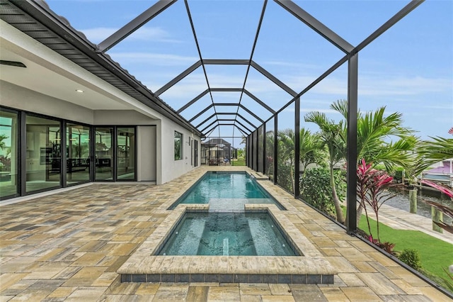 view of swimming pool with an in ground hot tub, a lanai, and a patio