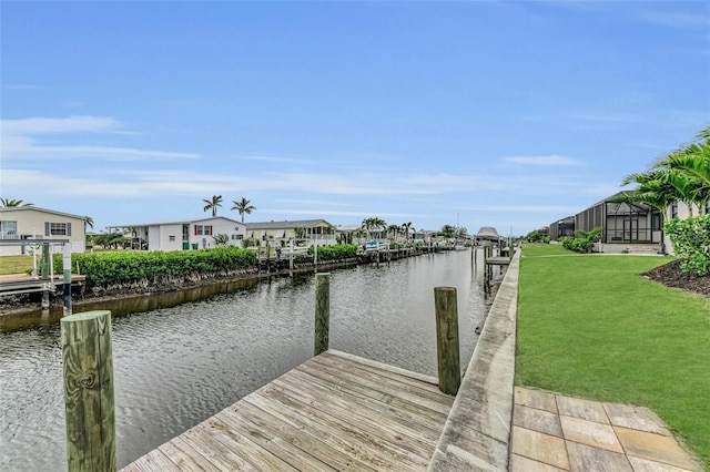 view of dock featuring a water view and a lawn