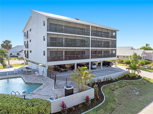 view of building exterior featuring a fenced in pool