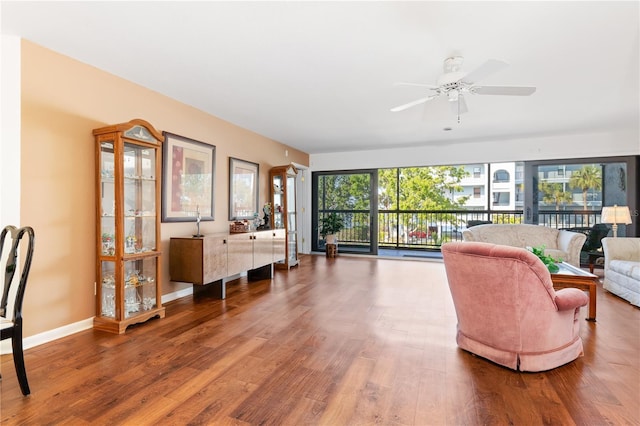 living room featuring ceiling fan and hardwood / wood-style floors