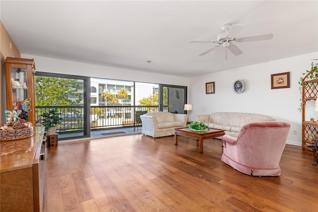 living room with ceiling fan and hardwood / wood-style floors