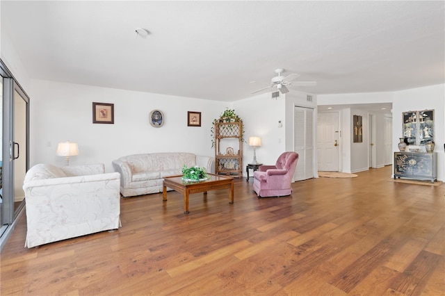 living room with hardwood / wood-style flooring and ceiling fan