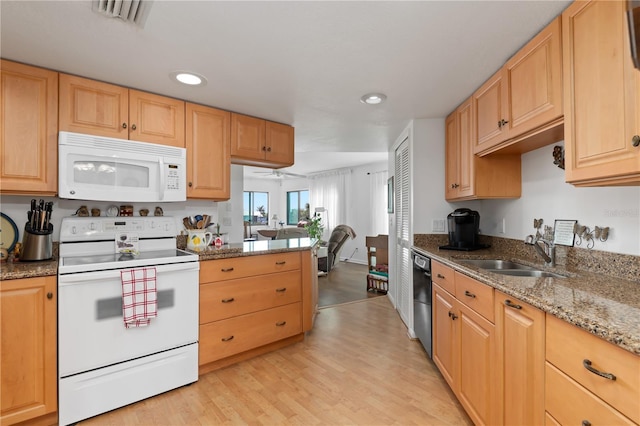 kitchen with light stone countertops, white appliances, sink, ceiling fan, and light hardwood / wood-style flooring