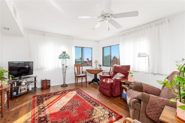 living room featuring ceiling fan and hardwood / wood-style flooring