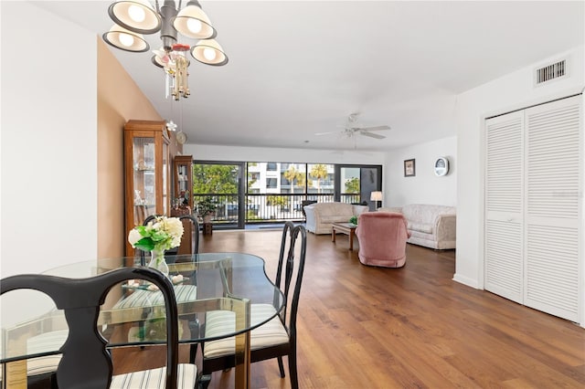 dining area featuring ceiling fan with notable chandelier and hardwood / wood-style flooring