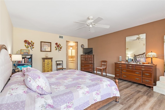 bedroom featuring ceiling fan, light wood-type flooring, and connected bathroom