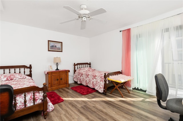 bedroom with ceiling fan and hardwood / wood-style floors