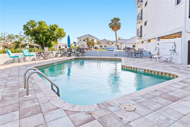 view of swimming pool featuring a patio area