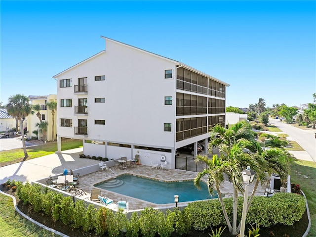 view of building exterior with a community pool