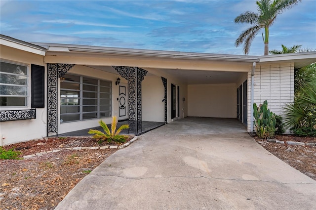 doorway to property with a carport