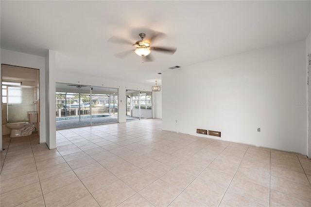 spare room featuring ceiling fan and light tile patterned flooring