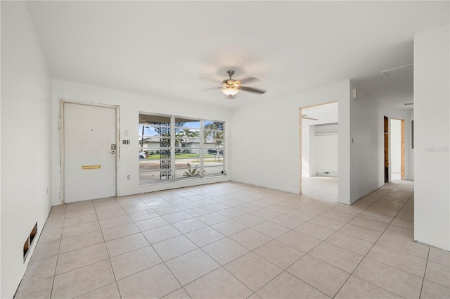 tiled spare room featuring ceiling fan