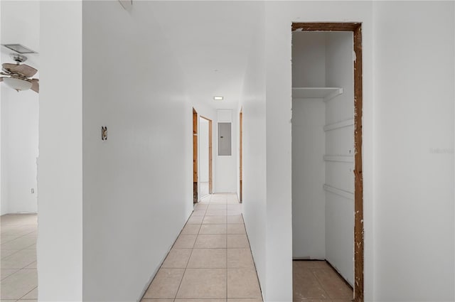 corridor with light tile patterned floors and electric panel