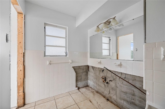 bathroom featuring tile patterned flooring and tile walls