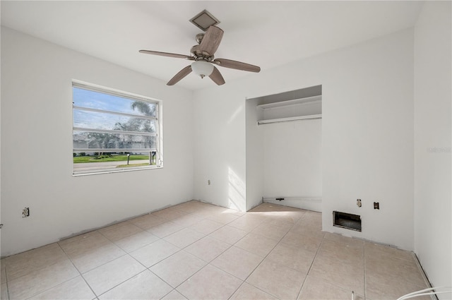 spare room featuring ceiling fan and light tile patterned floors