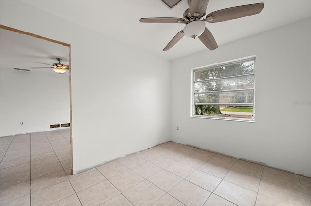 unfurnished room featuring ceiling fan and light tile patterned floors