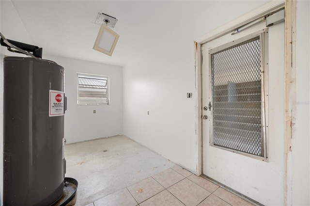 interior space with water heater and light tile patterned floors