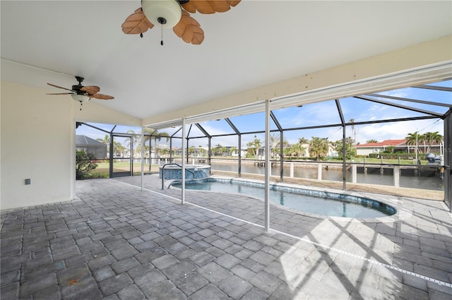 view of pool with a water view, a patio, and a lanai