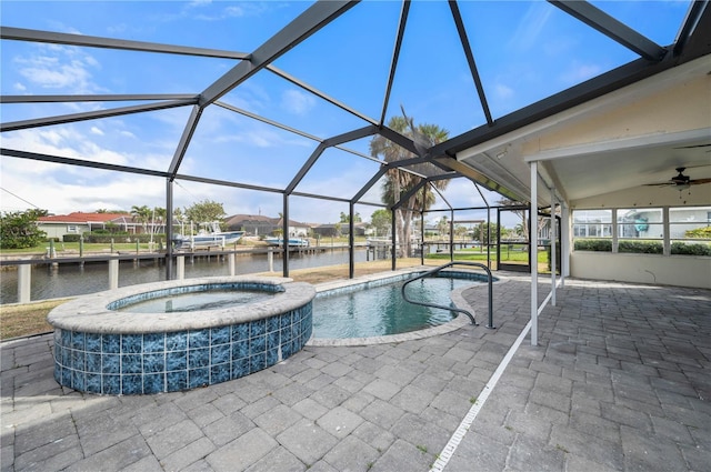 view of swimming pool with a lanai, a water view, an in ground hot tub, and a patio