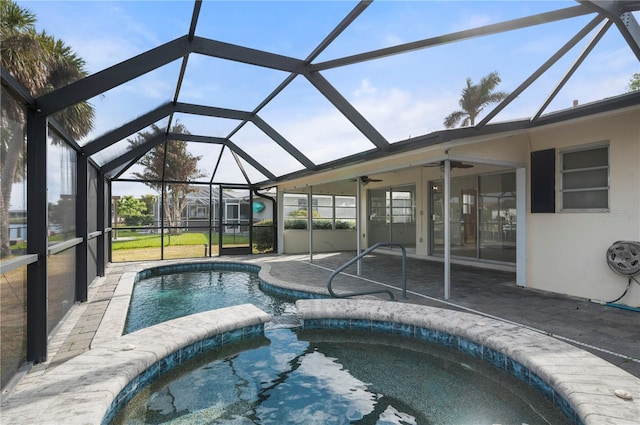 view of pool with glass enclosure, ceiling fan, and a patio