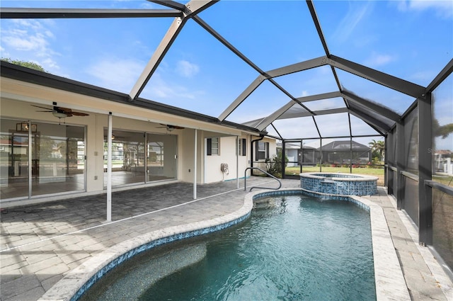 view of swimming pool with ceiling fan, a patio area, a lanai, and an in ground hot tub