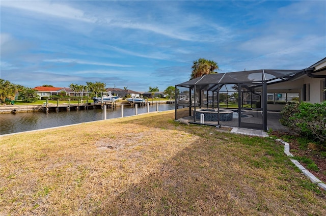 view of yard featuring a water view and glass enclosure