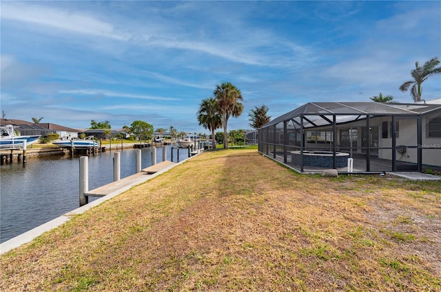 dock area featuring glass enclosure, a water view, and a lawn