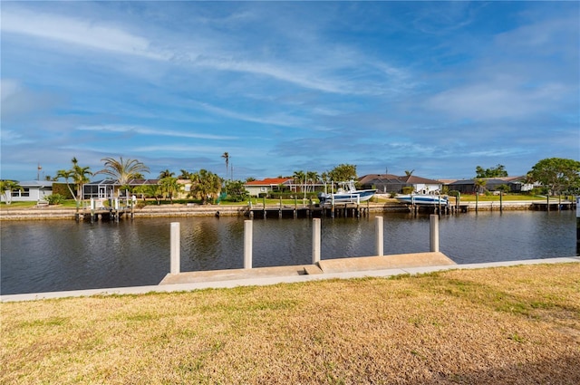 dock area with a water view and a yard