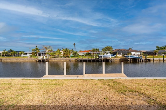 dock area with a yard and a water view