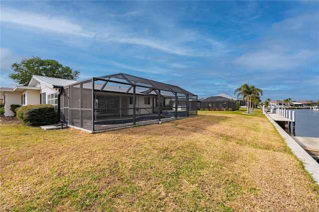 view of yard featuring a water view and glass enclosure