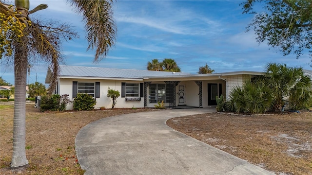 ranch-style house featuring a carport