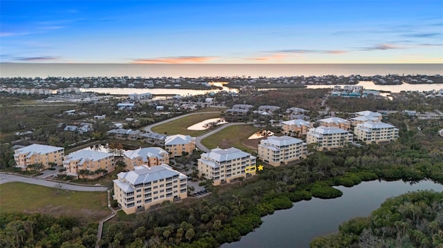 aerial view at dusk with a water view