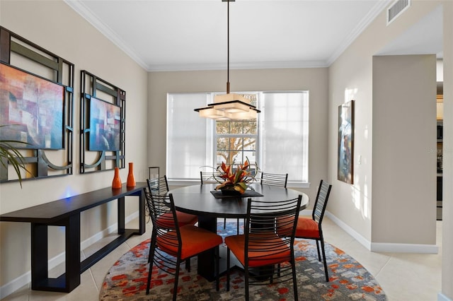 dining space featuring light tile patterned floors and crown molding