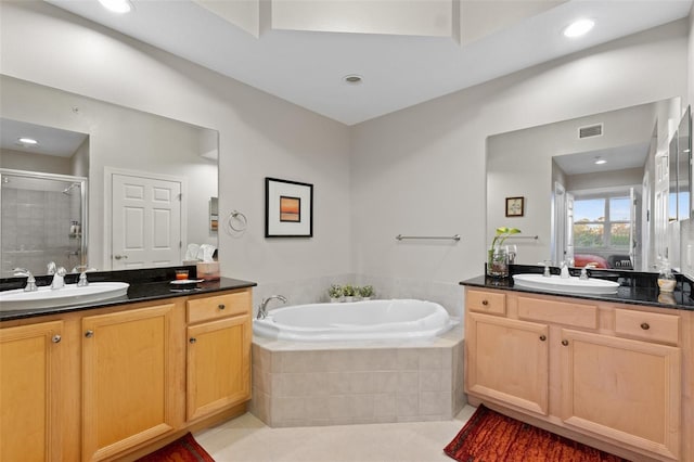 bathroom featuring vanity, tile patterned flooring, and plus walk in shower