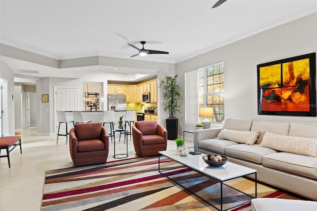 living room with light tile patterned floors, crown molding, a raised ceiling, and ceiling fan