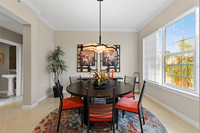 tiled dining area with crown molding and sink