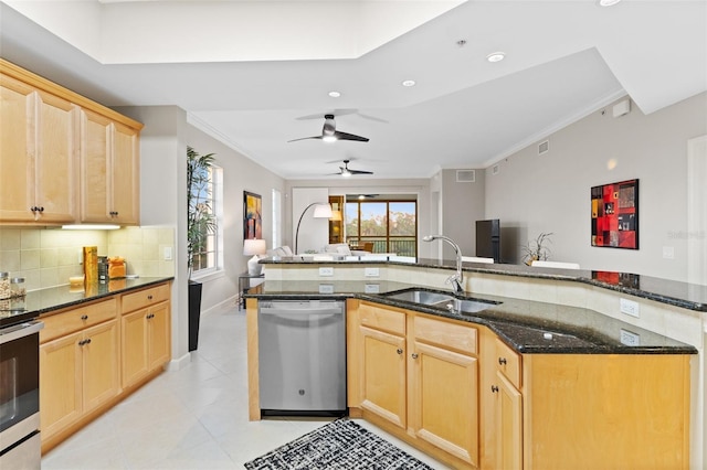 kitchen featuring appliances with stainless steel finishes, tasteful backsplash, sink, dark stone countertops, and crown molding