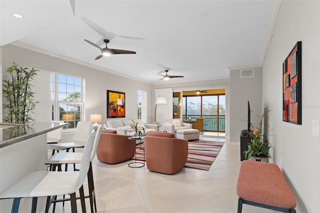 living room featuring crown molding, ceiling fan, and light tile patterned floors