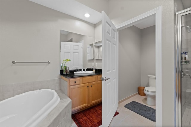 full bathroom featuring vanity, tile patterned floors, toilet, and separate shower and tub