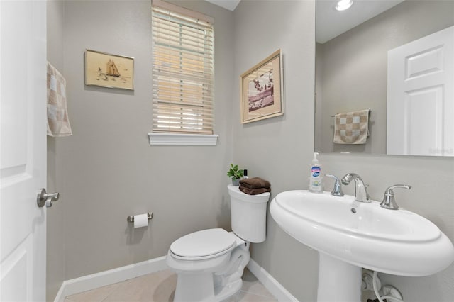 bathroom featuring tile patterned floors, toilet, and sink