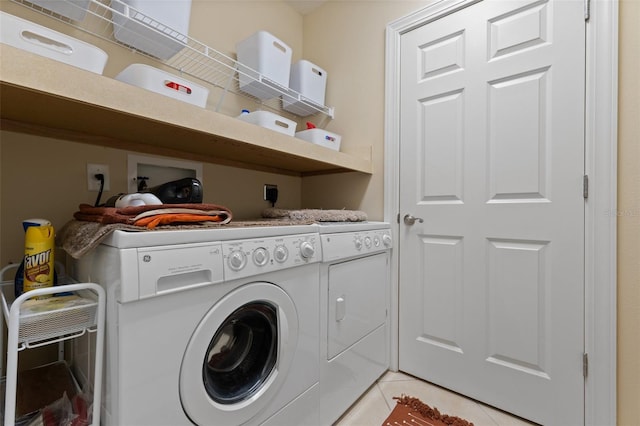 washroom featuring separate washer and dryer and light tile patterned floors