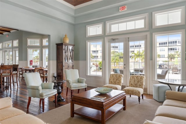 living room featuring a healthy amount of sunlight, light wood-type flooring, and french doors