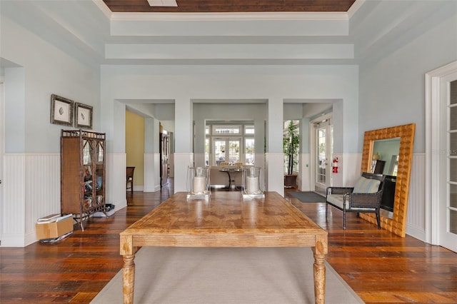 foyer entrance with dark hardwood / wood-style flooring, ornamental molding, and a high ceiling