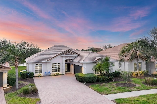 single story home with a yard and a garage