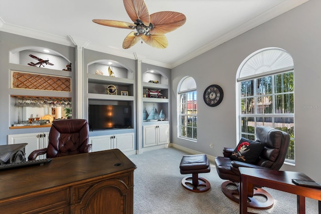 office space with ceiling fan, light colored carpet, built in shelves, and plenty of natural light