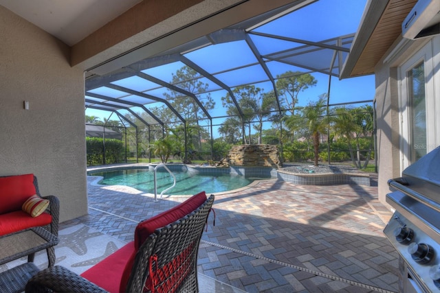 view of pool featuring glass enclosure, area for grilling, a jacuzzi, and a patio